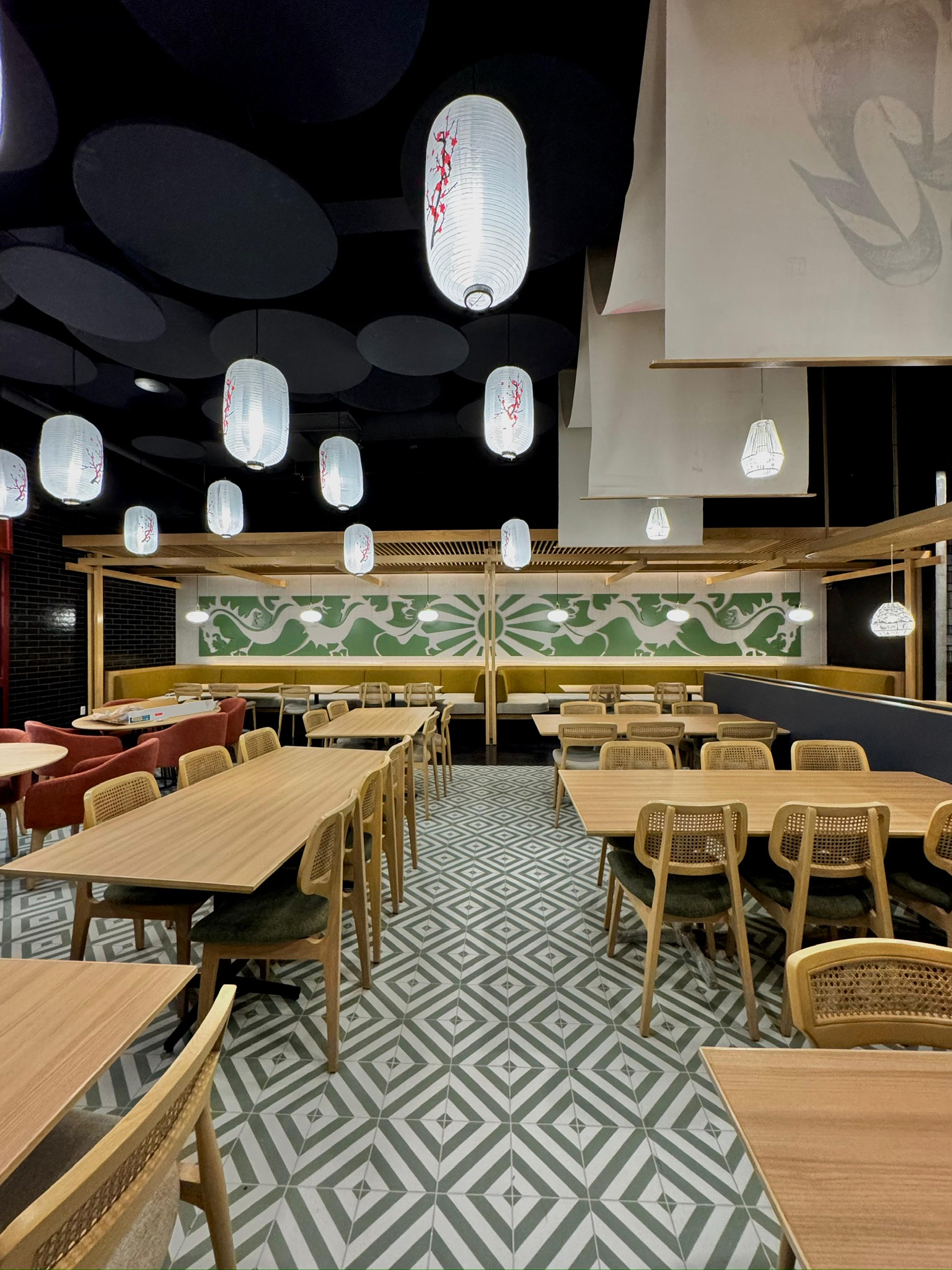 Ginsoy Houston — banquette seating against the green dragon mural, framed by the diamond-pattern tile floor
